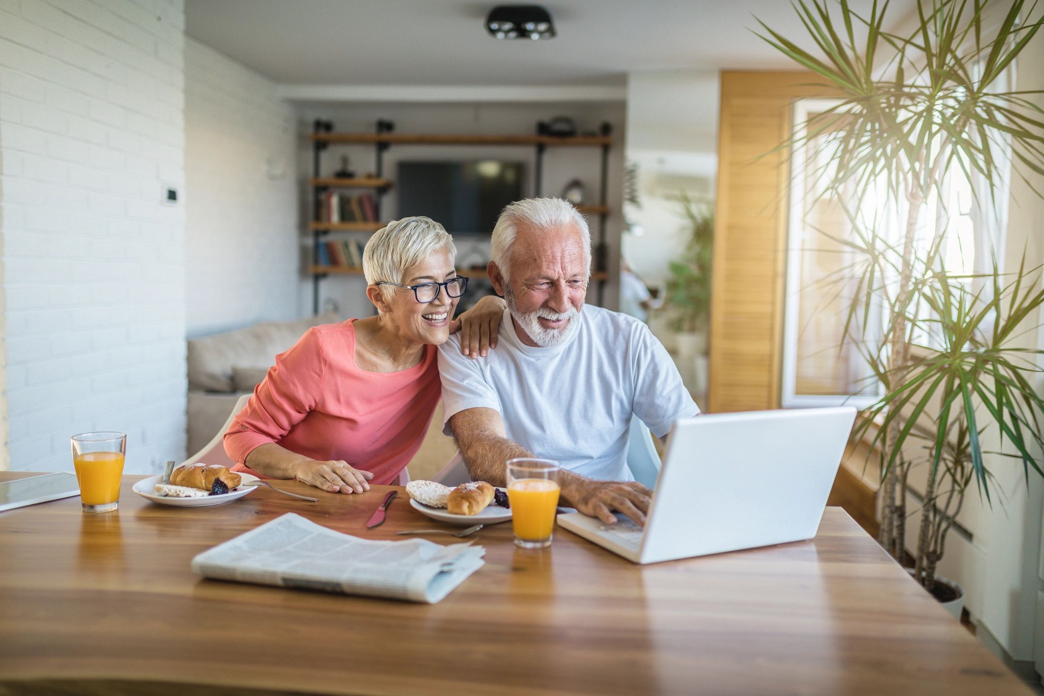 Senior couple managing finances online at home