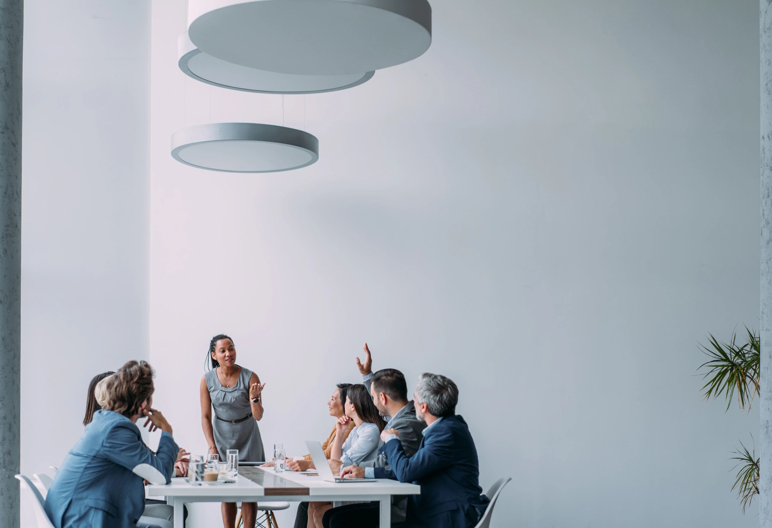 Businesswoman presenting financial ideas to a team in a meeting room