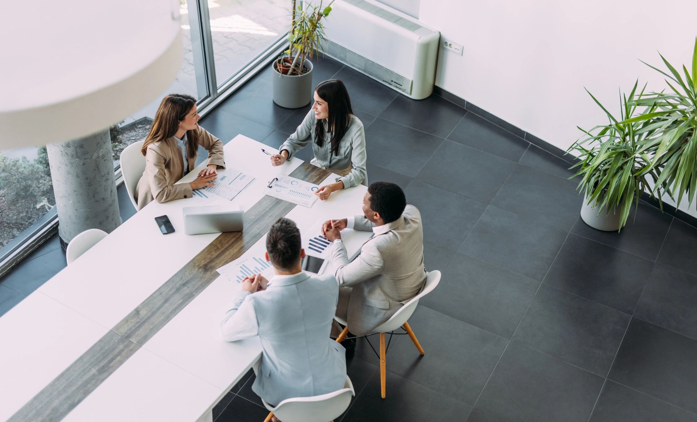 Team meeting around a conference table discussing financial strategy